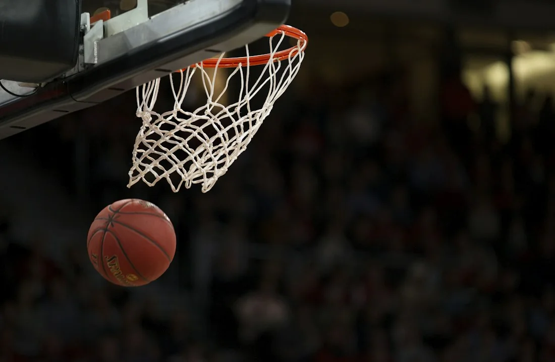A basketball approaching a hoop